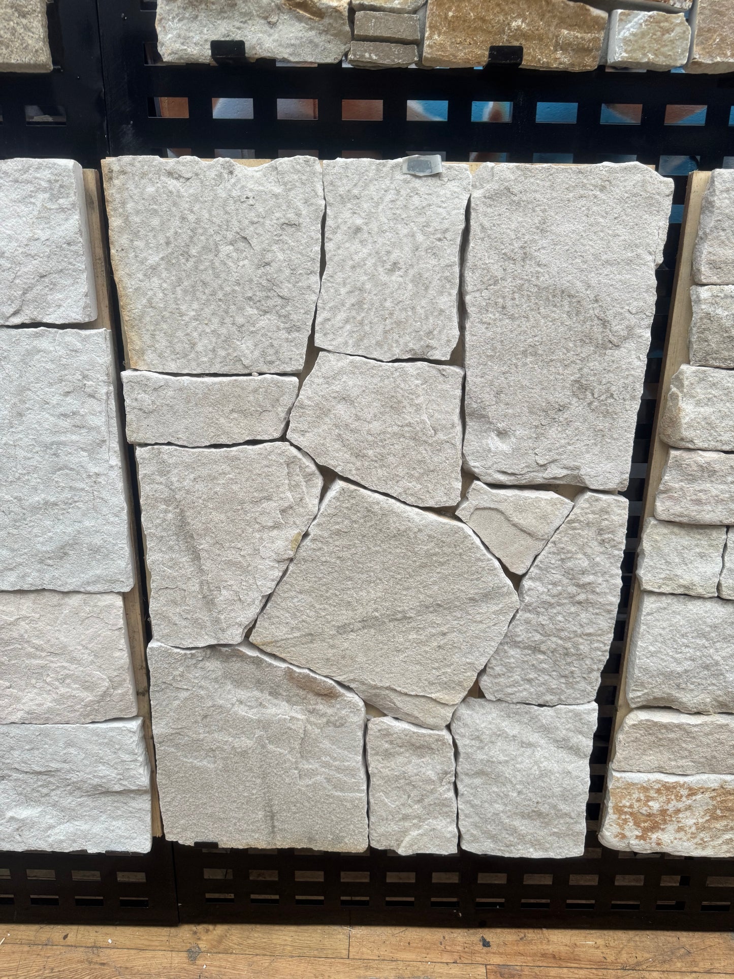 White mixed sandstone from The Nurso, showing textured natural stone with varied shades and rough surface details.