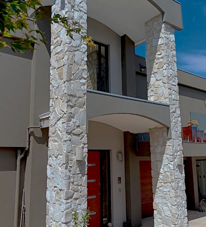 Ivory white quartz stone wall cladding with diagonal natural stone pattern by The Nurso, showcasing textured and elegant surface.