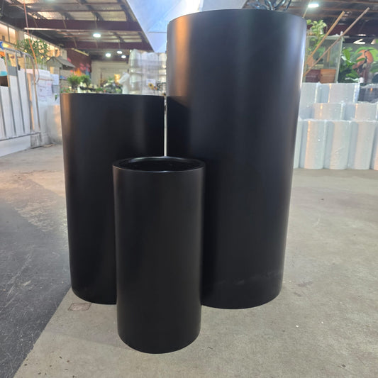Black Cedar tall cylinder pot with a sleek, modern design, featuring a smooth finish and a tall, cylindrical shape.