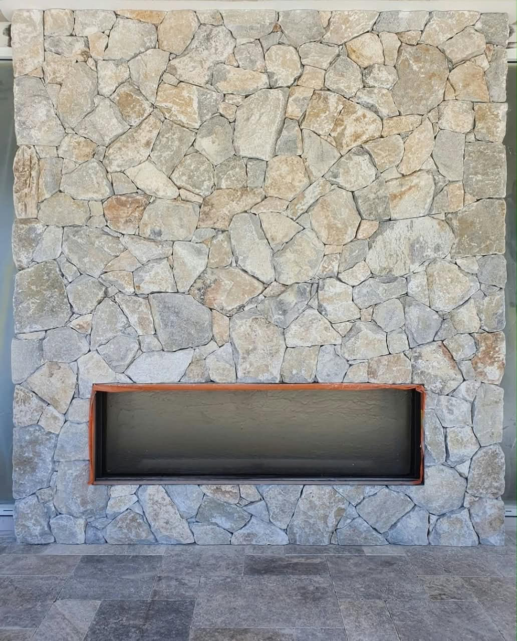 Yellow pearl stone cladding from The Nurso, showing textured natural stone surface with a warm yellow hue.