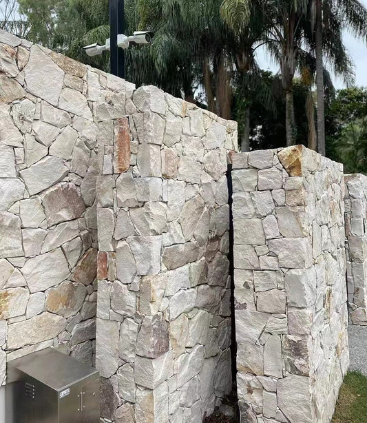 White and rusty sandstone stone wall cladding by The Nurso, showing textured surface and natural stone pattern for exterior or interior walls.