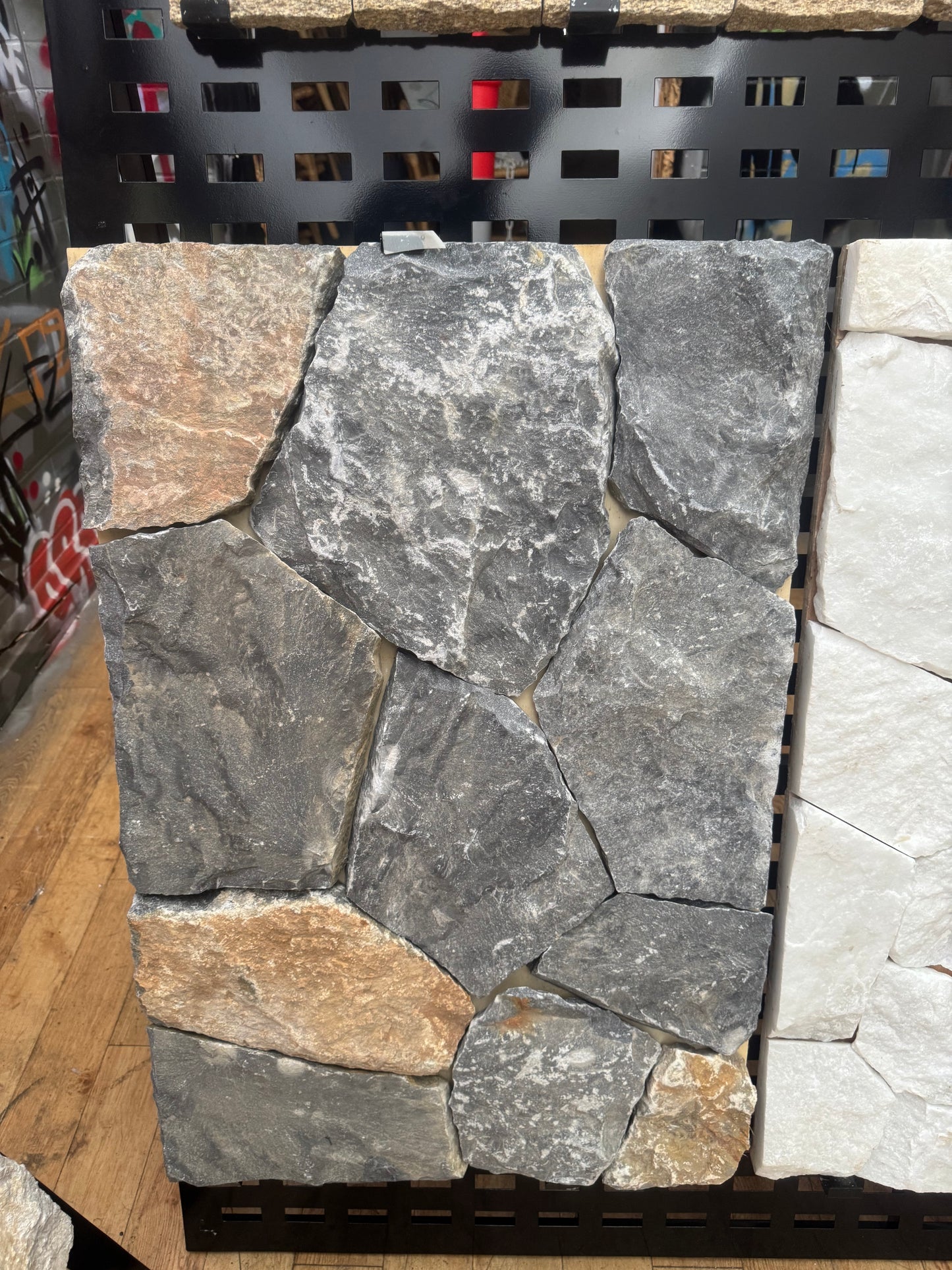 Blue limestone tile from The Nurso showing a smooth, polished surface with natural blue-gray veining and textured edges.