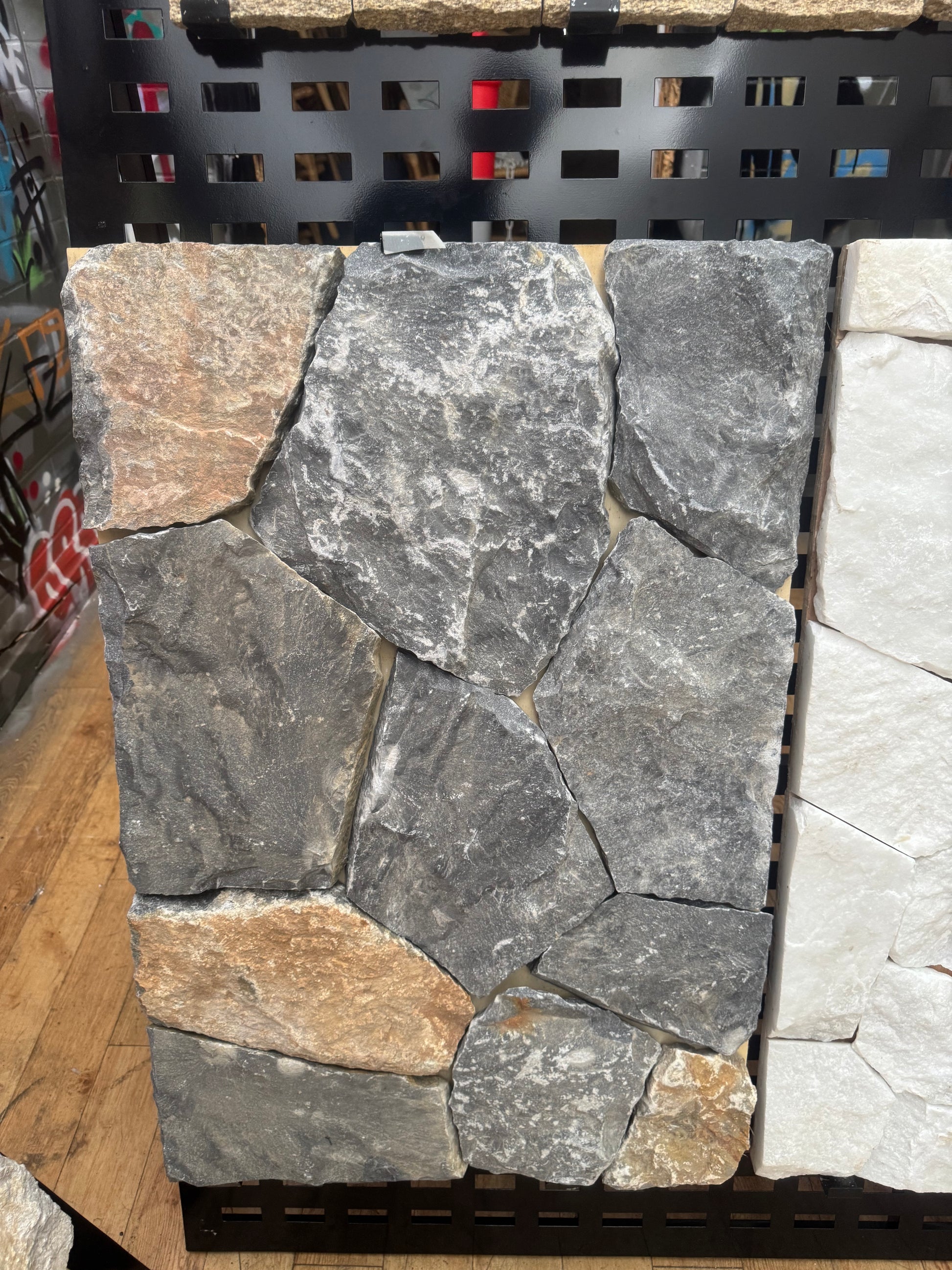 Blue limestone tile from The Nurso showing a smooth, polished surface with natural blue-gray veining and textured edges.