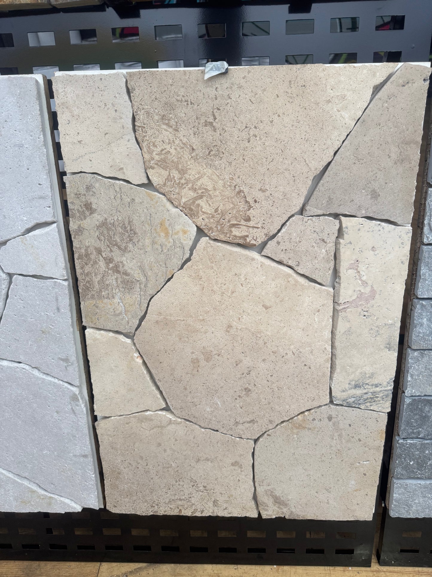 Cream travertine crazy paving from The Nurso, showing a natural uneven pattern of textured stone tiles for outdoor or patio use.
