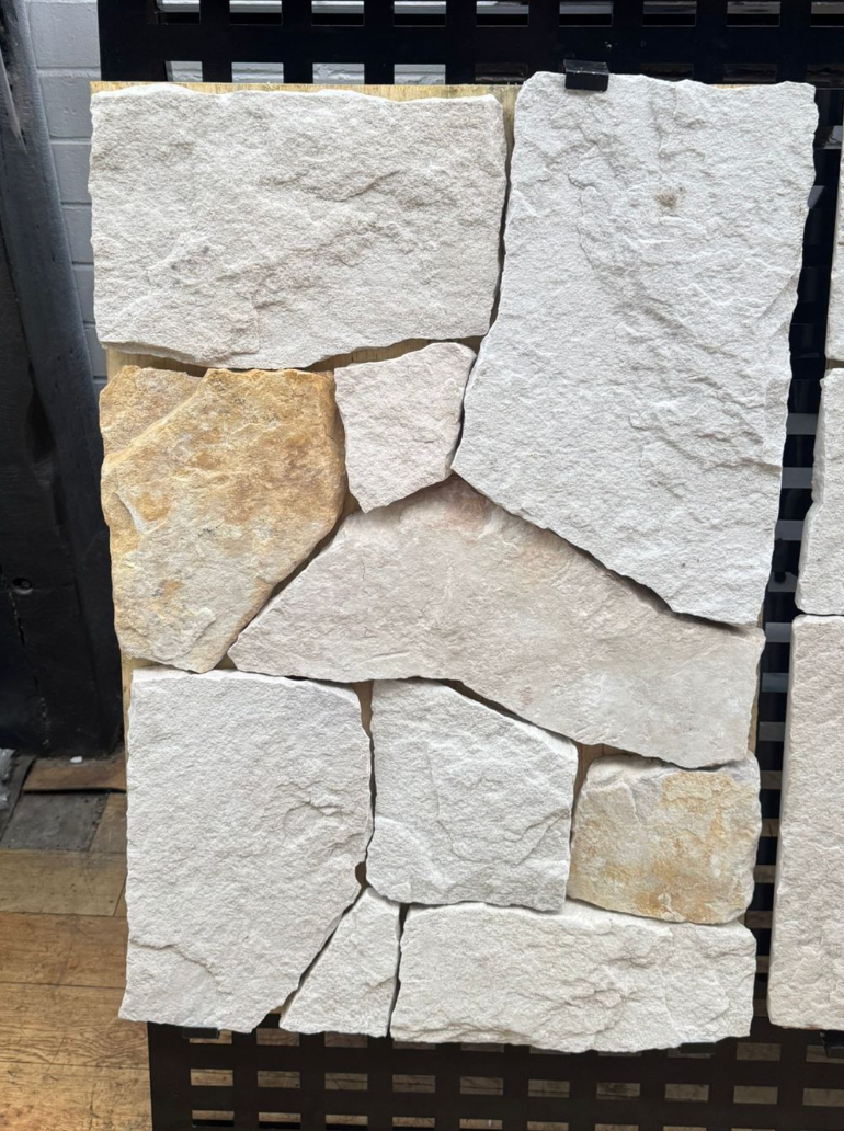White and rusty sandstone wall cladding from The Nurso, showing textured stone panels for outdoor or interior wall decoration.