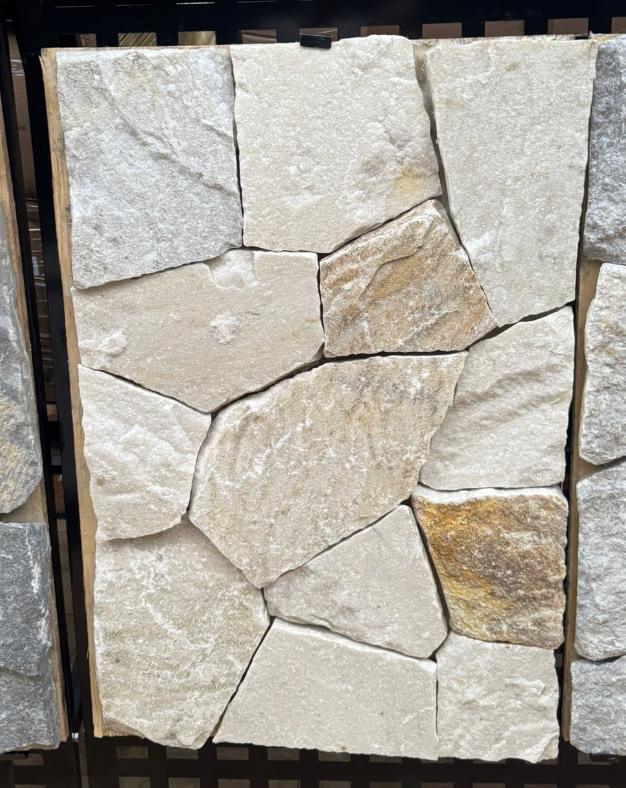 Beige and white quartz wall cladding with diagonal natural stone pattern by The Nurso, showcasing textured stone surface.