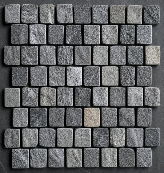 Gray slate cobblestones from The Nurso, showing textured surface and irregular shapes for outdoor walkways or patios.