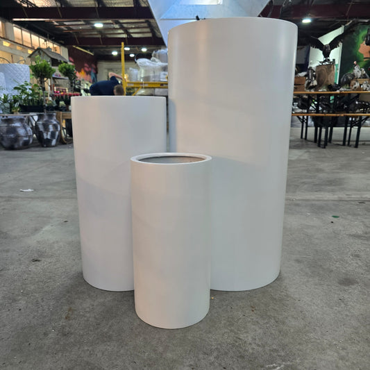 White cedar tall cylinder from The Nurso, showcasing a sleek, modern wood centerpiece with smooth finish and natural grain details.