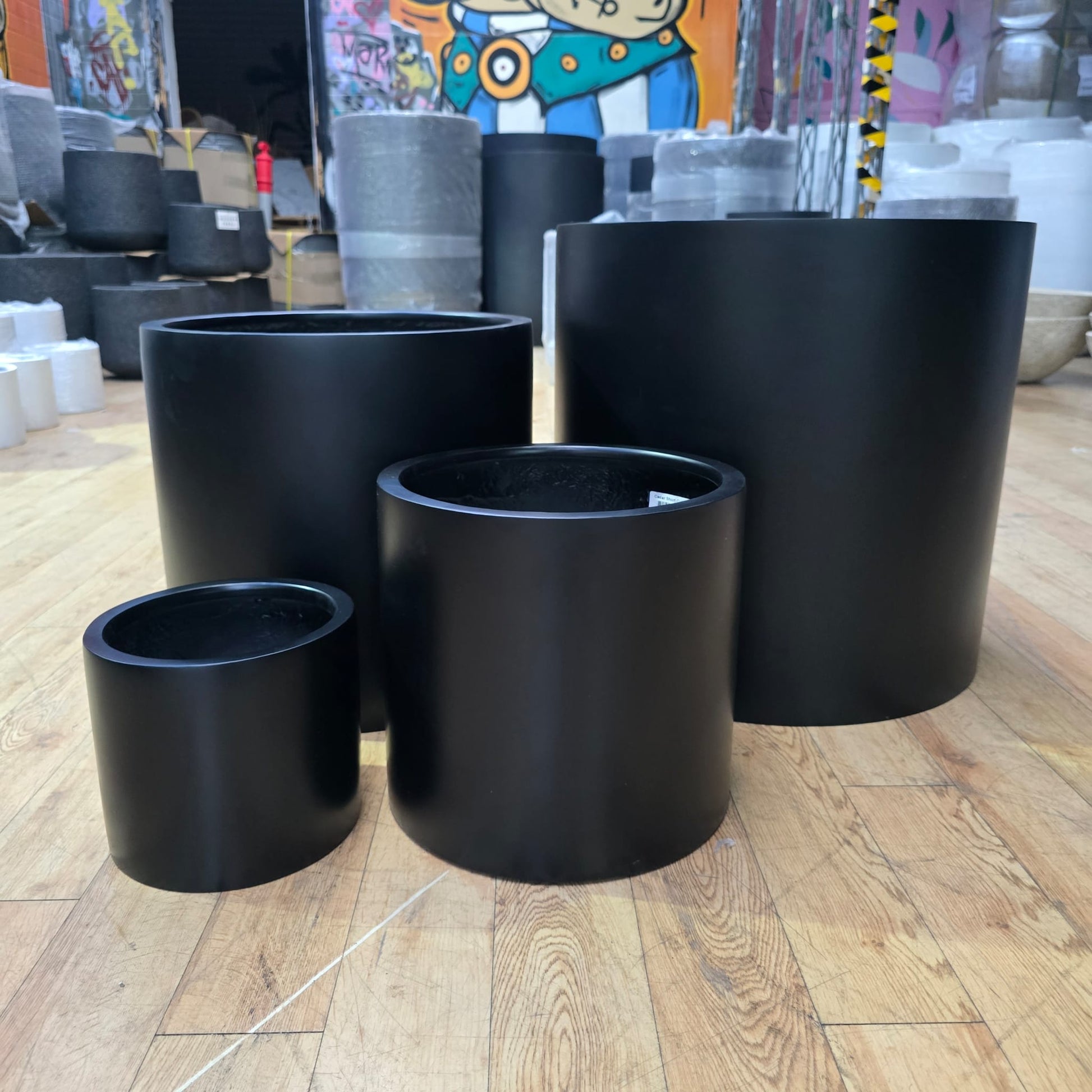 Black Cedar Cylinder Pot with a sleek design, measuring 23cm tall and 23cm wide, ideal for indoor or outdoor plant display.