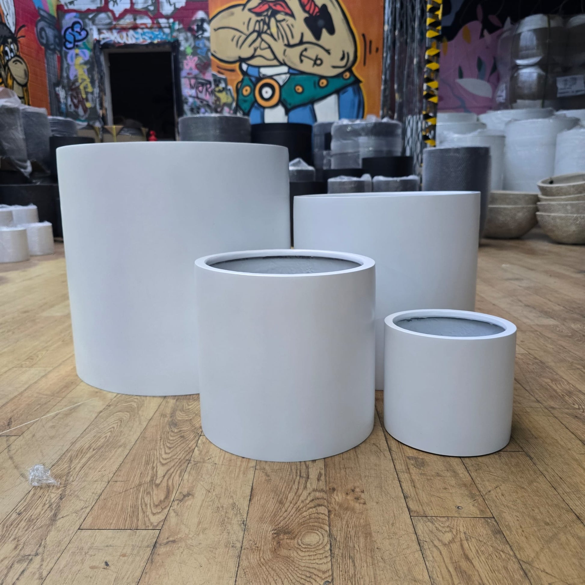 White cedar cylinder pot with a smooth finish, measuring 23cm in diameter and height, ideal for decorative plants.