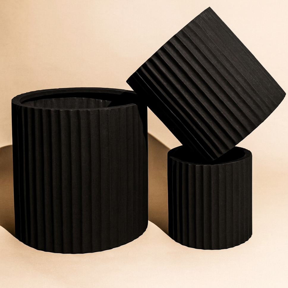 Black cedar ribbed cylinder pot with a sleek, modern design, ideal for indoor or outdoor plants.