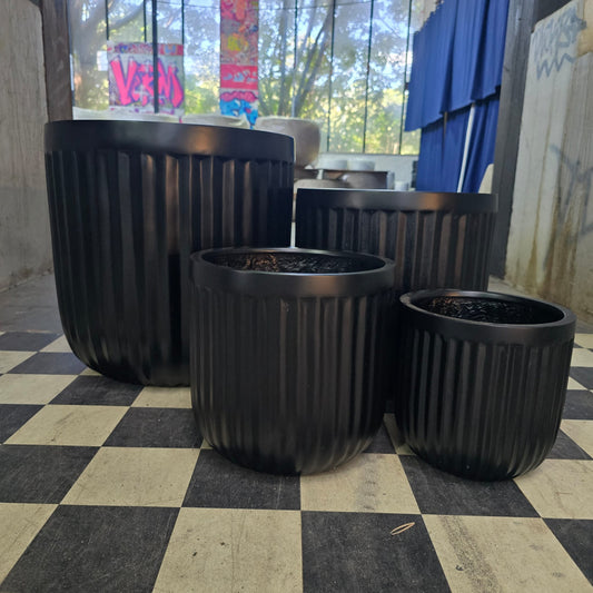 Cedar Ribbed Egg Black by The Nurso showing a smooth, ribbed design in black on a neutral background