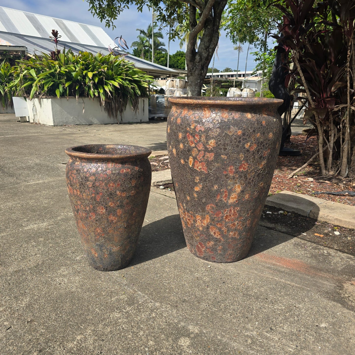 Rust-colored Atlantis wide jar pot with a sturdy, wide design, perfect for outdoor or garden decor.