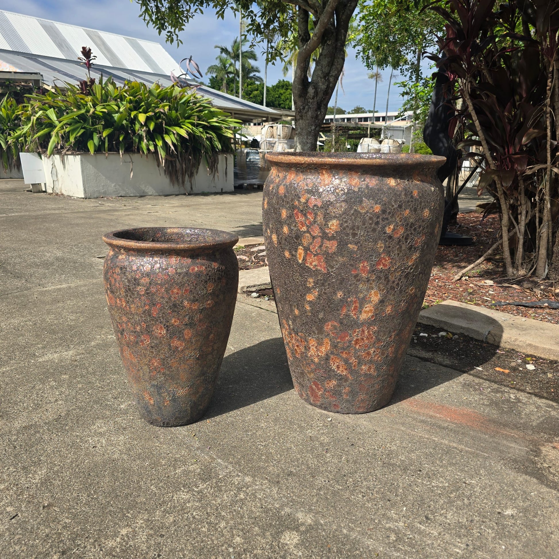 Rust-colored Atlantis wide jar pot with a sturdy, wide design, perfect for outdoor or garden decor.