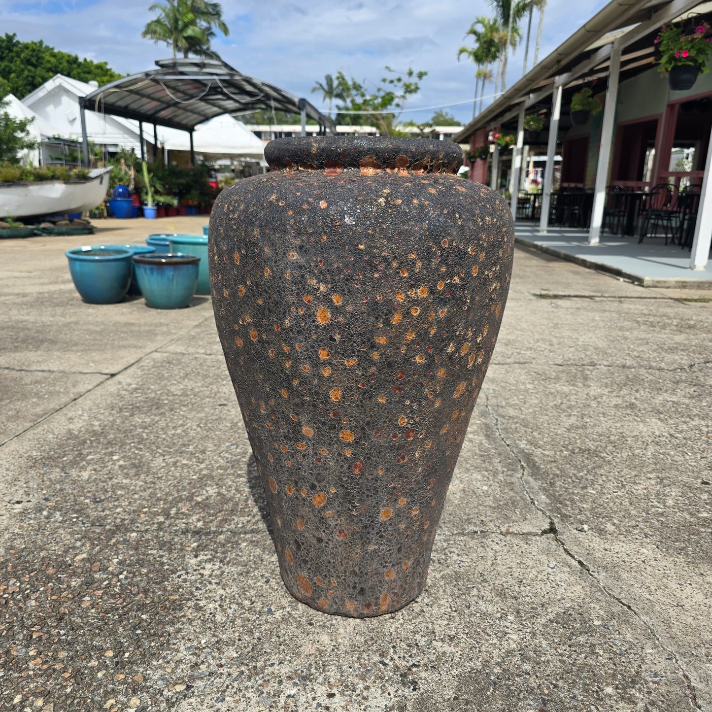Rust-colored Atlantis Narrow Jar Pot by Atlantis, tall ceramic planter with a sleek, narrow design and textured surface.